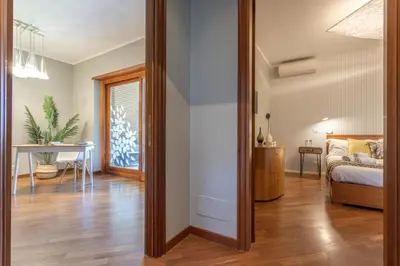 a room with a bed and a table and a mirror at Kitty Apartment - Close to the Vatican in Rome