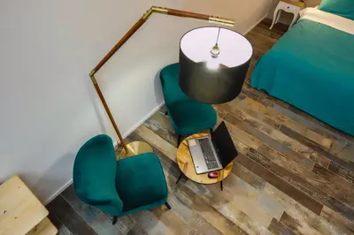an overhead view of a bedroom with a laptop on a table and chairs at Rosso Cortese in Rome