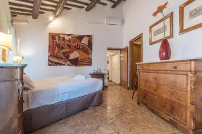 a bedroom with a bed and a wooden dresser at By the charming Piazza Navona - FromHometoRome in Rome