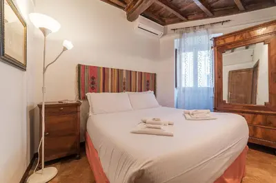 a bedroom with a bed with two towels on it at By the charming Piazza Navona - FromHometoRome in Rome