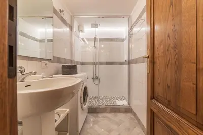 a white bathroom with a sink and a shower at By the charming Piazza Navona - FromHometoRome in Rome