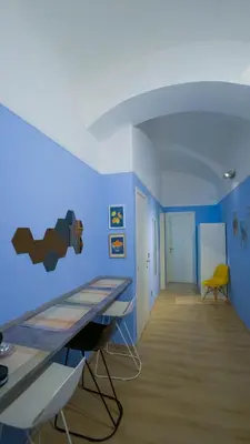 a room with a table and a blue wall at Domus Vatican Museum in Rome