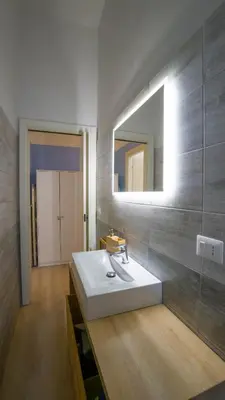 a bathroom with a white sink and a mirror at Domus Vatican Museum in Rome