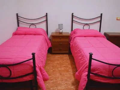 two beds sitting next to each other in a room at Ostello Marello in Rome