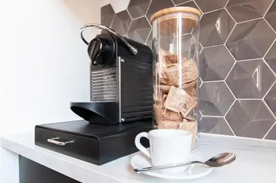 a coffee maker and a cup on a counter at Casa di Artemisia in Rome