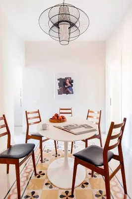 a dining room with a white table and chairs at Casa di Artemisia in Rome