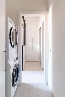 a white laundry room with a washer and dryer at Casa di Artemisia in Rome