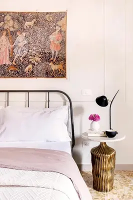 a bedroom with a bed and a painting on the wall at Casa di Artemisia in Rome