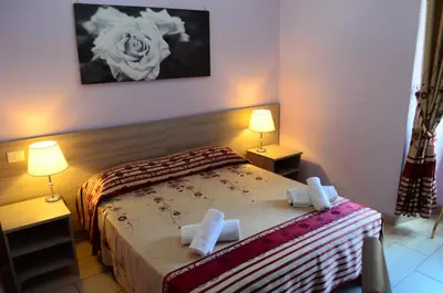 a bedroom with a bed with two towels on it at Roma Castle Termini in Rome