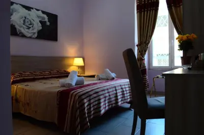 a hotel room with a bed with towels on it at Roma Castle Termini in Rome