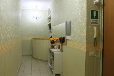 a hallway of a hospital with a room with flowers at Roma Castle Termini in Rome