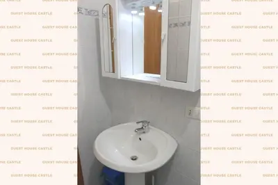 a bathroom with a white sink and a mirror at Roma Castle Termini in Rome