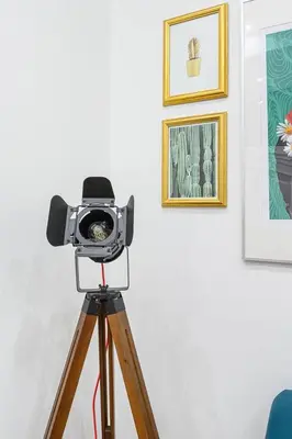 a camera on a tripod in a room with paintings at Design Suite Trevi Fountain in Rome