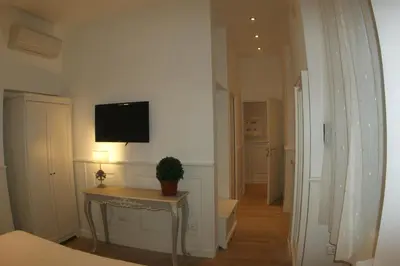 a room with a table and a tv on a wall at Alba Sul Vaticano in Rome