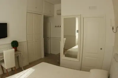 a bedroom with a bed and a door with a mirror at Alba Sul Vaticano in Rome