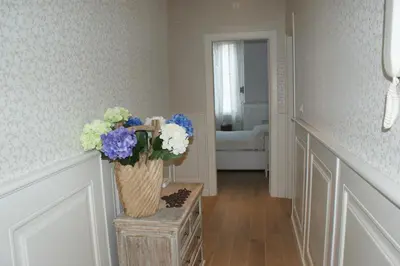a hallway with a vase of flowers on a table at Alba Sul Vaticano in Rome