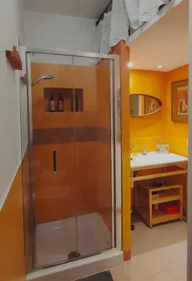 a glass shower in a bathroom with a sink at Il nido al Colosseo in Rome