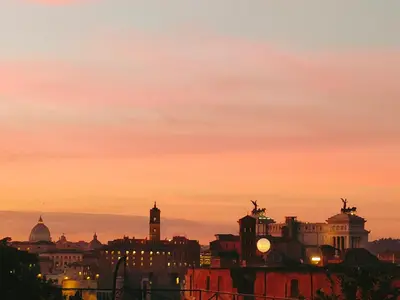 a view of a city skyline at sunset at Il nido al Colosseo in Rome