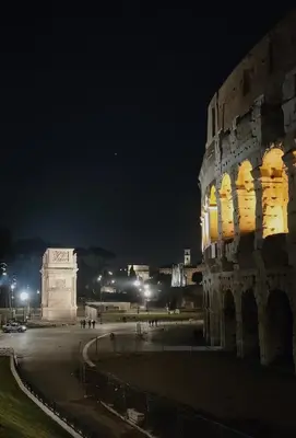 a building with yellow lights on it at night at Il nido al Colosseo in Rome