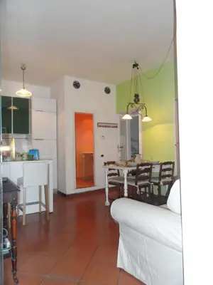 a kitchen and living room with a table and chairs at Il nido al Colosseo in Rome