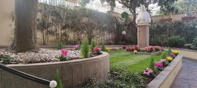 a garden with flowers and a statue next to a fence at Villa Angeli in Rome