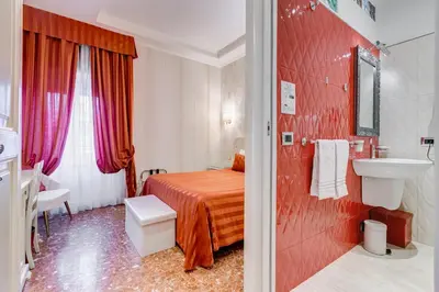 a hotel room with a bed and a sink and a bathroom at Navona Queen Rooftop in Rome