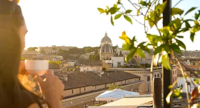 a bedroom with a bed and a chair and a window at Navona Queen Rooftop in Rome