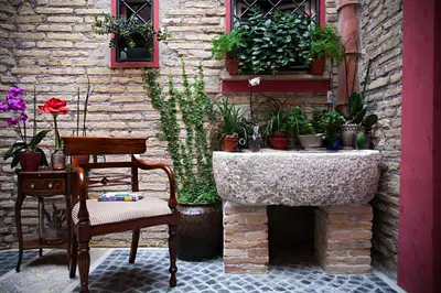 a bedroom with a bed and a window with blue curtains at Navona Queen Rooftop in Rome