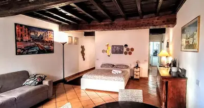 a living room with a bed and a couch at Sweet Home Panisperna in Rome
