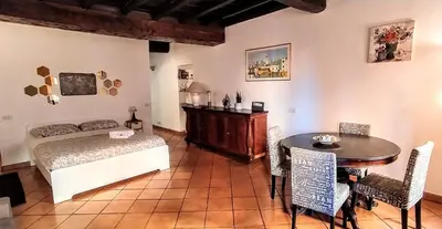 a bedroom with a bed and a table and a table and chairs at Sweet Home Panisperna in Rome