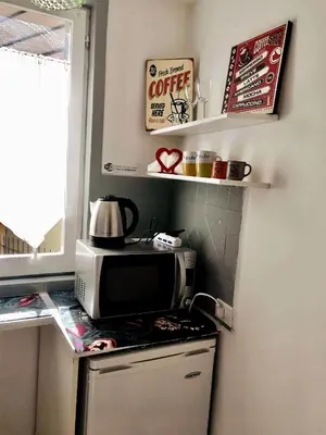 a kitchen with a microwave on top of a counter at Sweet Home Panisperna in Rome