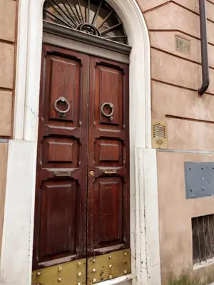a wooden door on the side of a building at Sweet Home Panisperna in Rome