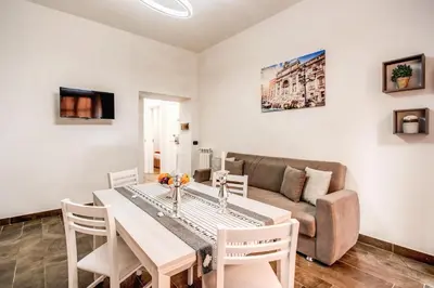 a living room with a table and a couch at Laura luxury apartment in the center Rome in Rome