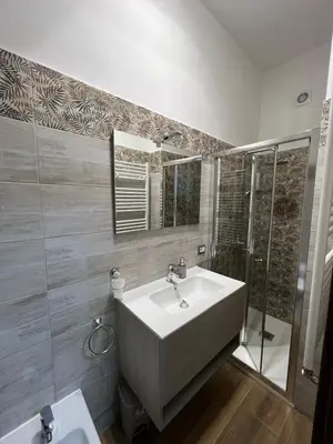 a bathroom with a white sink and a shower at Laura luxury apartment in the center Rome in Rome