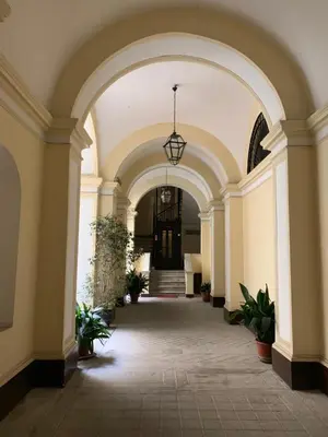 an archway in a building with potted plants at TimeRoma in Rome