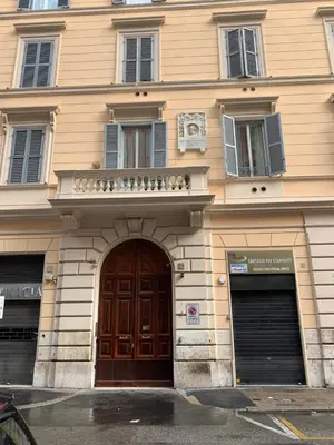 a building with a large wooden door and windows at TimeRoma in Rome