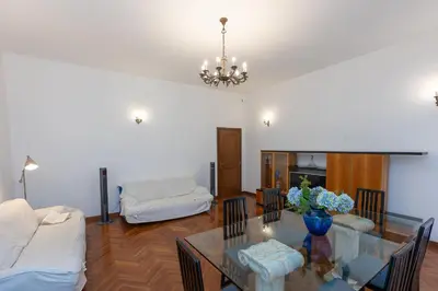 a living room with a glass table and a couch at TimeRoma in Rome
