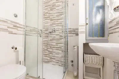 a bathroom with a shower and a toilet and a sink at Vatican Rooms Irene in Rome