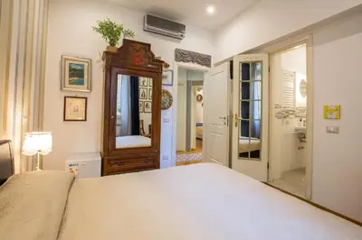 a bedroom with a bed and a dresser and a mirror at Vatican Rooms Irene in Rome