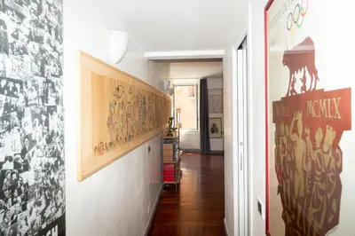 a hallway with black and white pictures on the walls at DomusAmor Navona in Rome