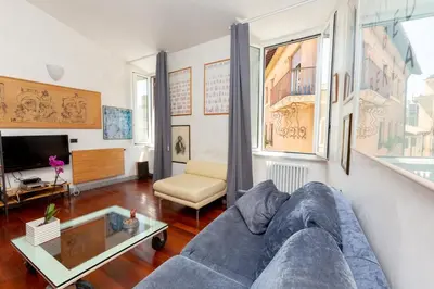 a living room with a couch and a tv at DomusAmor Navona in Rome