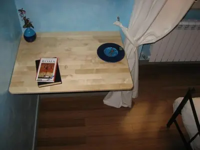 a table with a book on top of it at DomusAmor Colosseo in Rome