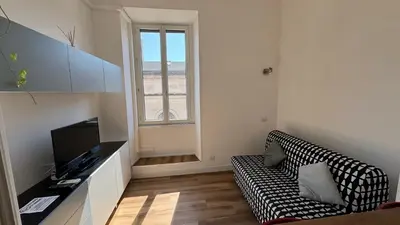 a living room with a couch and a television at The Rica House in Rome