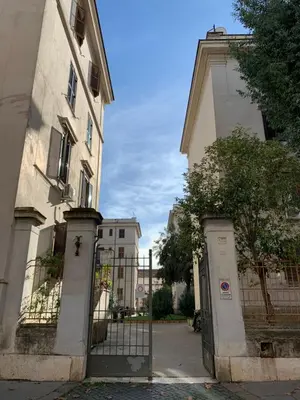 a gate in front of a building next to a building at The Rica House in Rome