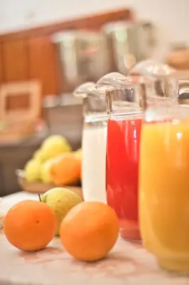 a table with oranges and pitchers of juice at Gästehaus Deutscher Orden in Rome