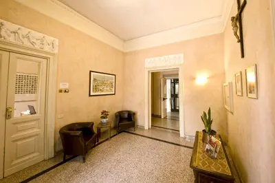 a hallway with chairs and a table and a door at Gästehaus Deutscher Orden in Rome