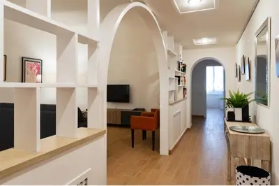 a living room with an archway and a living room with a table at A casa di Rosanna in Rome