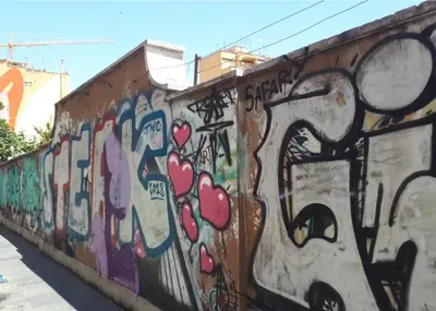 a wall with alot of graffiti on it at A casa di Rosanna in Rome