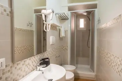 a bathroom with a sink and a shower and a toilet at A casa di Rosanna in Rome