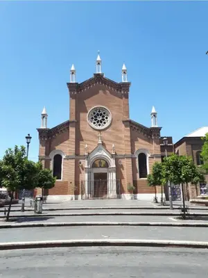 a large brick church with a clock on the front at A casa di Rosanna in Rome